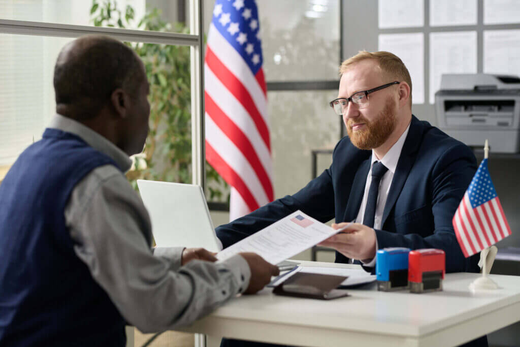 worker handing visa application to man 2022 12 08 00 44 46 utc