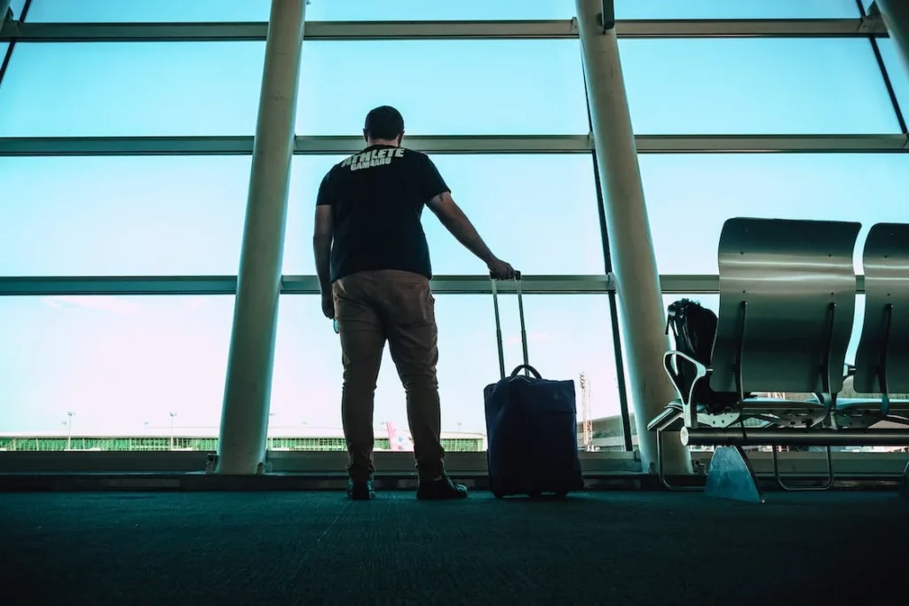 Man with suitcase about to leave the country